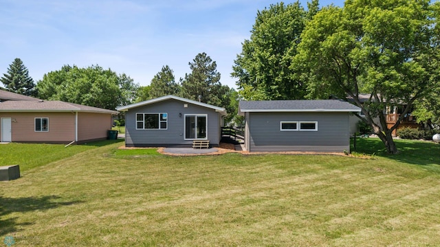 1031 7th St W, West Fargo, ND 58078 - back of house with a yard and an outbuilding