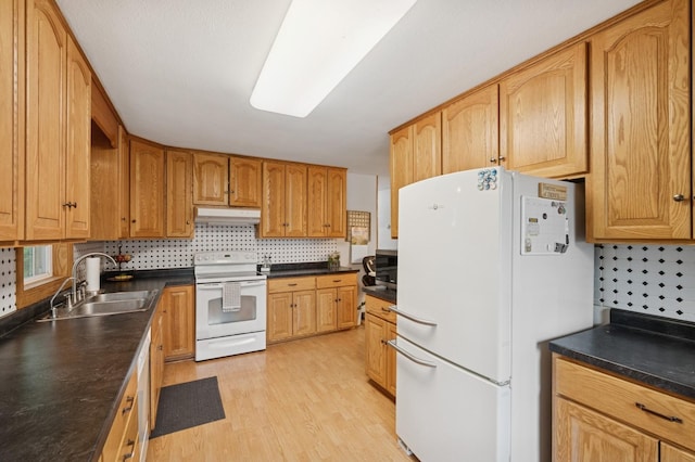 9372 71st St NE, Spicer, MN 56288 - kitchen with white appliances, under cabinet range hood, light wood-style floors, decorative backsplash, and dark countertops
