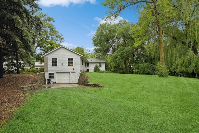 9372 71st St NE, Spicer, MN 56288 - view of grassy yard featuring an attached garage and driveway