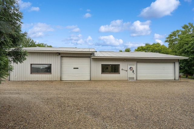 9372 71st St NE, Spicer, MN 56288 - view of front of property featuring a garage, a metal roof, and driveway
