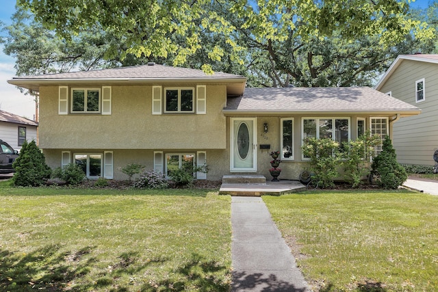 4128 Zane Ave N, Robbinsdale, MN 55422 - split level home featuring stucco siding and a front yard