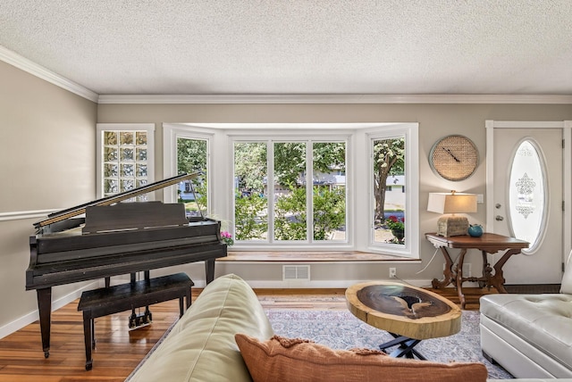 4128 Zane Ave N, Robbinsdale, MN 55422 - sitting room featuring wood finished floors, ornamental molding, and a textured ceiling
