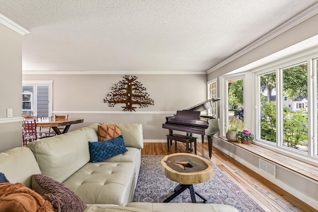 4128 Zane Ave N, Robbinsdale, MN 55422 - living room featuring a textured ceiling, wood finished floors, and ornamental molding