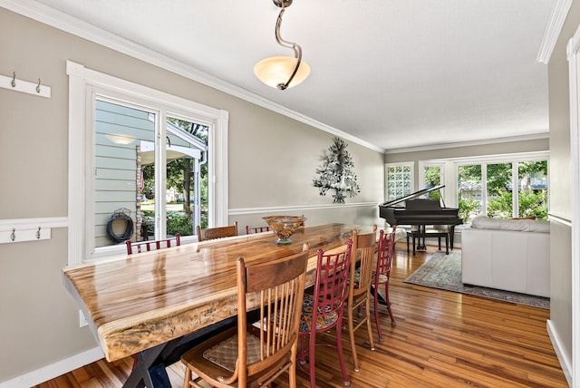 4128 Zane Ave N, Robbinsdale, MN 55422 - dining room featuring healthy amount of natural light, ornamental molding, and hardwood / wood-style flooring