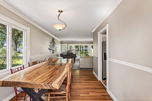 4128 Zane Ave N, Robbinsdale, MN 55422 - dining room featuring wood finished floors, plenty of natural light, and ornamental molding