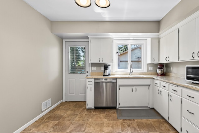 4128 Zane Ave N, Robbinsdale, MN 55422 - kitchen featuring stainless steel appliances, healthy amount of natural light, light countertops, and white cabinets