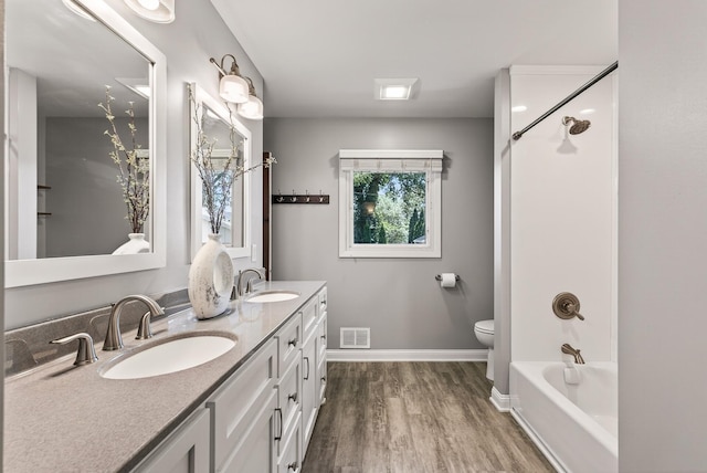 4128 Zane Ave N, Robbinsdale, MN 55422 - bathroom with wood finished floors, double vanity, and washtub / shower combination