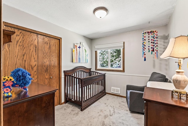 4128 Zane Ave N, Robbinsdale, MN 55422 - bedroom featuring carpet flooring, a textured ceiling, a nursery area, and a wainscoted wall