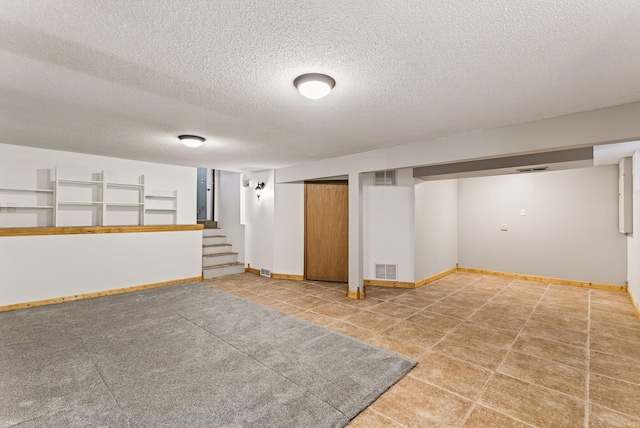 4128 Zane Ave N, Robbinsdale, MN 55422 - finished basement with a textured ceiling, stairs, and tile patterned floors