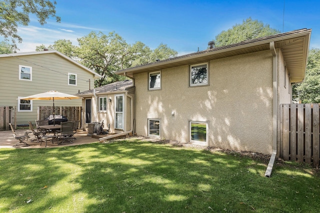 4128 Zane Ave N, Robbinsdale, MN 55422 - rear view of house with stucco siding and a patio