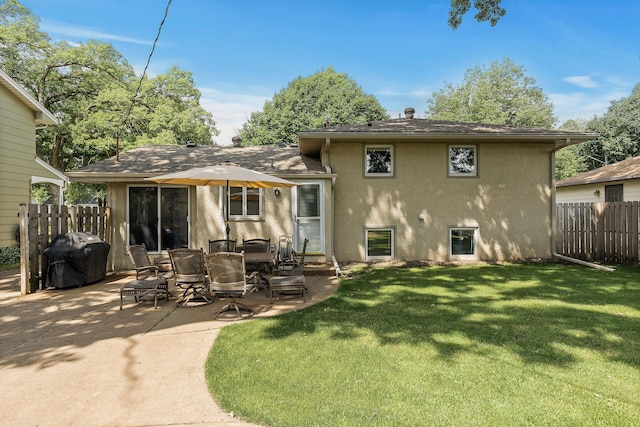 4128 Zane Ave N, Robbinsdale, MN 55422 - rear view of house with stucco siding and a patio