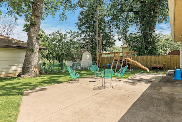 4128 Zane Ave N, Robbinsdale, MN 55422 - fenced backyard featuring a playground, a patio area, and an outbuilding