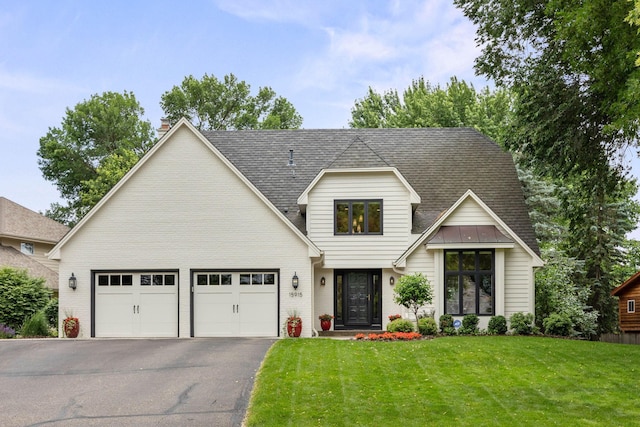 15915 46th Ave N, Plymouth, MN 55446 - view of front of home featuring a garage, driveway, brick siding, a front yard, and a shingled roof