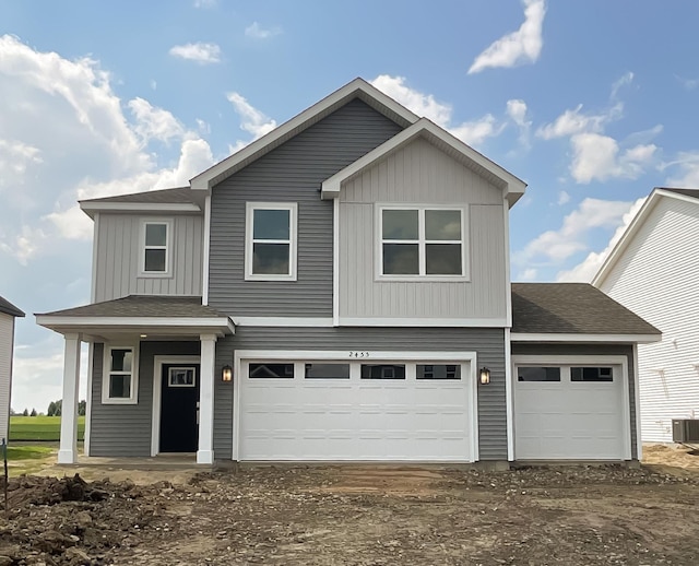 2455 Jandell Ave NE, Saint Michael, MN 55376 - view of front facade featuring roof with shingles, an attached garage, board and batten siding, and dirt driveway