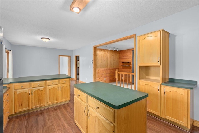2224 75th Ave Unit M, Osceola, WI 54020 - kitchen with dark countertops, dark wood-style flooring, a textured ceiling, a center island, and a peninsula