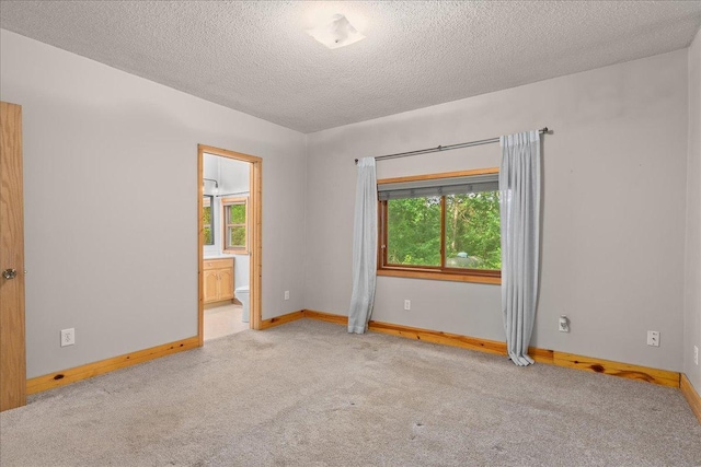2224 75th Ave Unit M, Osceola, WI 54020 - carpeted empty room featuring healthy amount of natural light and a textured ceiling