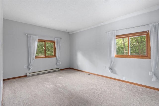 2224 75th Ave Unit M, Osceola, WI 54020 - carpeted empty room featuring a baseboard heating unit and healthy amount of natural light