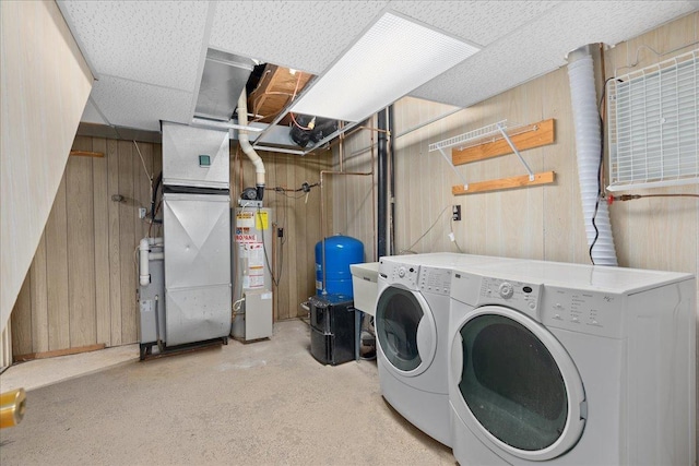 2224 75th Ave Unit M, Osceola, WI 54020 - laundry area featuring washer and clothes dryer, water heater, wooden walls, and heating unit