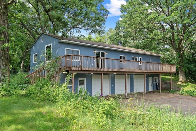 2224 75th Ave Unit M, Osceola, WI 54020 - rear view of property with a deck, a garage, driveway, and stairway
