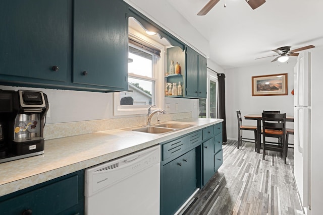 522 14th St NE, Owatonna, MN 55060 - kitchen featuring white appliances, a ceiling fan, light countertops, and light wood-type flooring