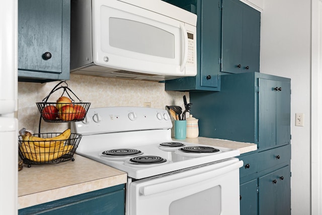 522 14th St NE, Owatonna, MN 55060 - kitchen featuring white appliances, blue cabinets, light countertops, and tasteful backsplash