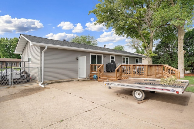 522 14th St NE, Owatonna, MN 55060 - back of property with a deck, a patio area, and a shingled roof