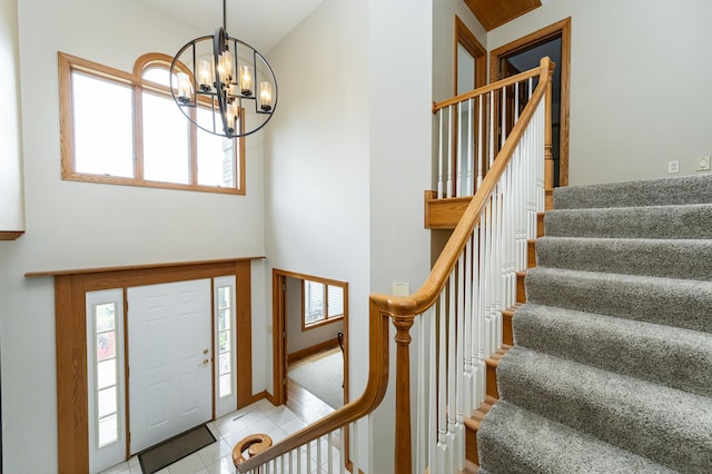 4354 48th St NE, Haverhill Twp, MN 55906 - foyer with a chandelier, stairs, tile patterned floors, and a towering ceiling