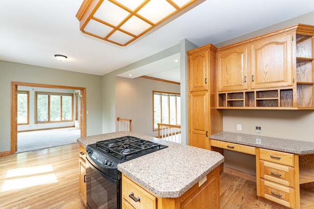 4354 48th St NE, Haverhill Twp, MN 55906 - kitchen with gas stove, open shelves, light wood-style flooring, built in desk, and plenty of natural light