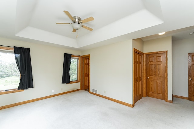 4354 48th St NE, Haverhill Twp, MN 55906 - empty room featuring light colored carpet, a tray ceiling, a ceiling fan, and a smoke detector