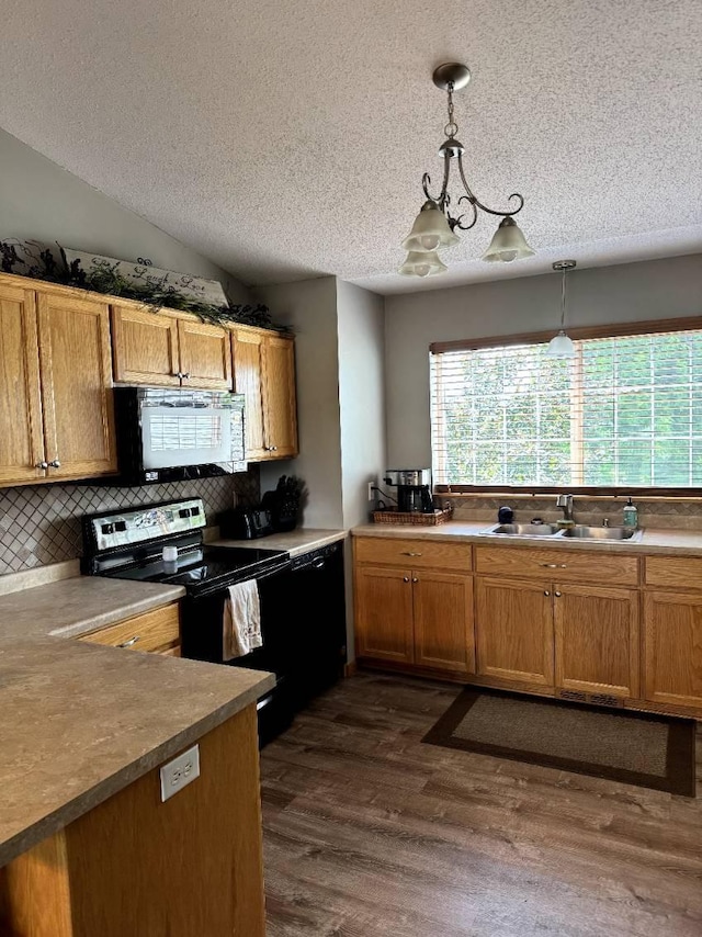 608 11th Ave SW, Rice, MN 56367 - kitchen featuring black appliances, a textured ceiling, decorative backsplash, dark wood-style flooring, and decorative light fixtures