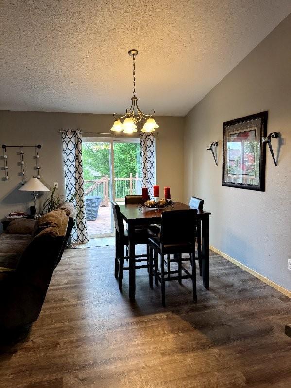 608 11th Ave SW, Rice, MN 56367 - dining space with a chandelier, wood finished floors, and a textured ceiling