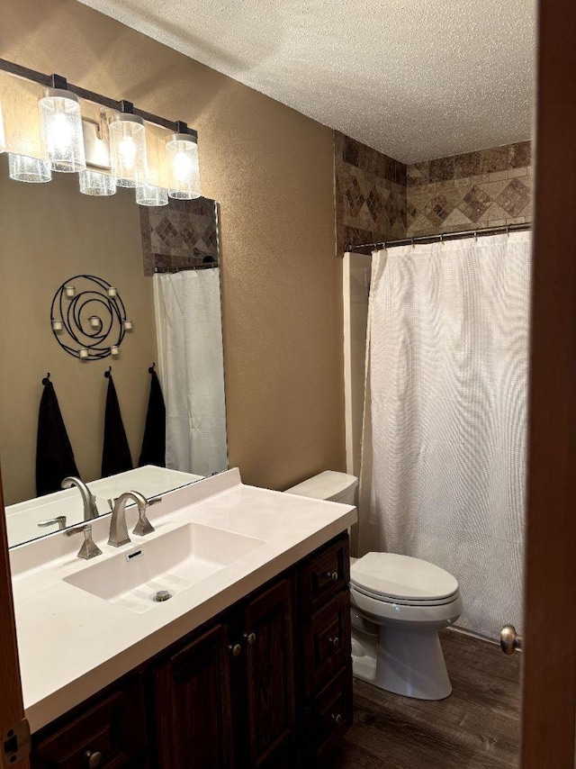 608 11th Ave SW, Rice, MN 56367 - bathroom with wood finished floors, vanity, a textured ceiling, a textured wall, and a shower with shower curtain