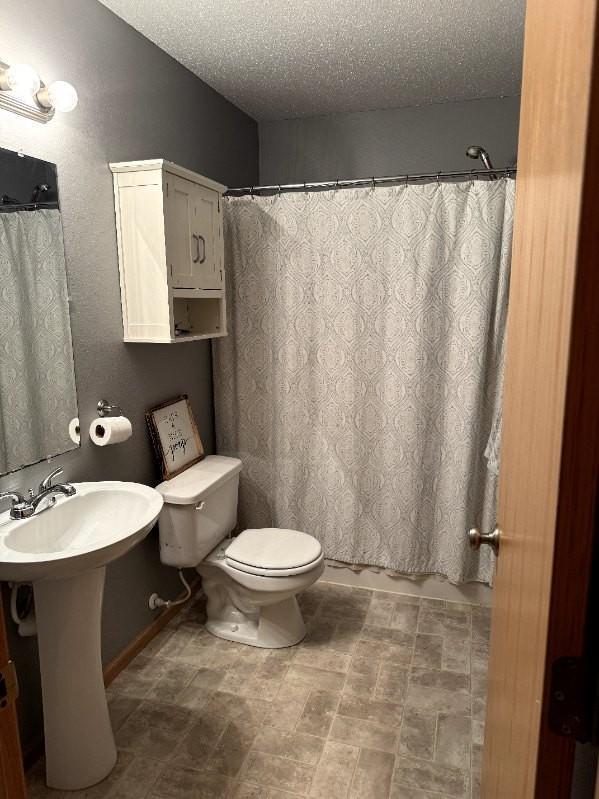 608 11th Ave SW, Rice, MN 56367 - full bathroom with a textured ceiling and a shower with shower curtain