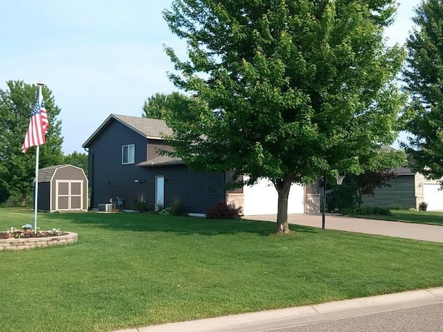 608 11th Ave SW, Rice, MN 56367 - view of home's exterior with concrete driveway, a storage unit, a yard, and a garage