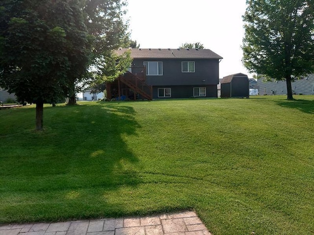 608 11th Ave SW, Rice, MN 56367 - view of grassy yard with stairway and a shed