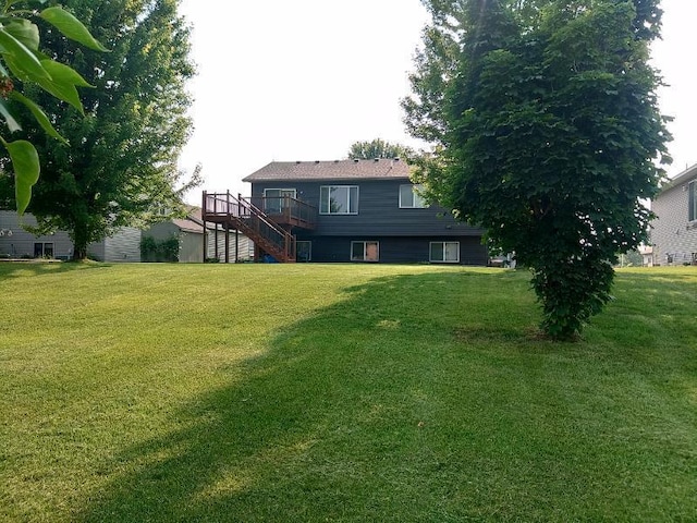 608 11th Ave SW, Rice, MN 56367 - view of green lawn with stairs and a wooden deck
