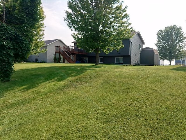 608 11th Ave SW, Rice, MN 56367 - view of grassy yard featuring stairs and a wooden deck