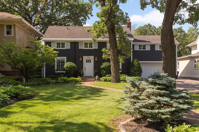 1064 Lombard Ave, Saint Paul, MN 55105 - colonial-style house featuring a chimney, a front yard, and a garage
