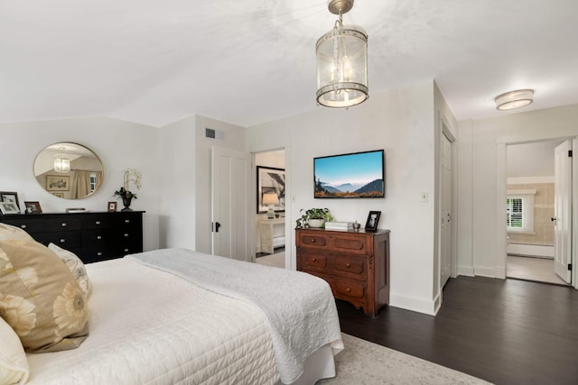 1064 Lombard Ave, Saint Paul, MN 55105 - bedroom with a baseboard heating unit, dark wood finished floors, connected bathroom, and vaulted ceiling