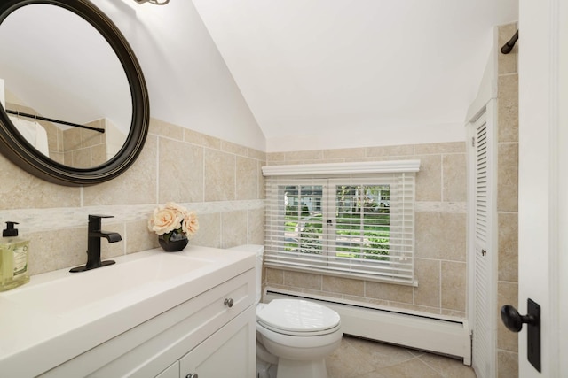 1064 Lombard Ave, Saint Paul, MN 55105 - full bathroom featuring a baseboard heating unit, tile walls, vanity, vaulted ceiling, and tile patterned floors