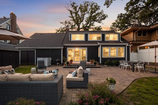 1064 Lombard Ave, Saint Paul, MN 55105 - back of house at dusk featuring outdoor lounge area, a patio, and a shed