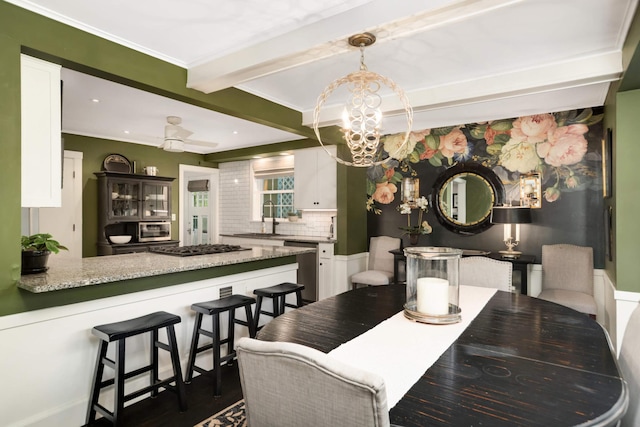 1064 Lombard Ave, Saint Paul, MN 55105 - dining room featuring beam ceiling, a chandelier, dark wood-style flooring, and ornamental molding