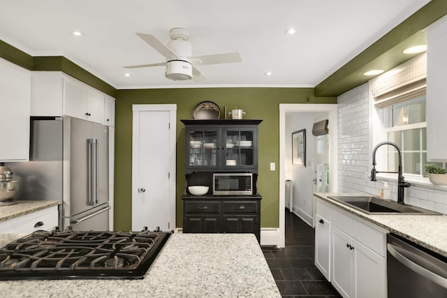 1064 Lombard Ave, Saint Paul, MN 55105 - kitchen with appliances with stainless steel finishes, white cabinets, recessed lighting, ceiling fan, and backsplash