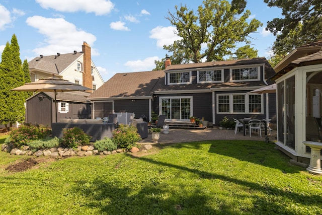 1064 Lombard Ave, Saint Paul, MN 55105 - rear view of house featuring a storage shed, a patio area, a yard, and a chimney
