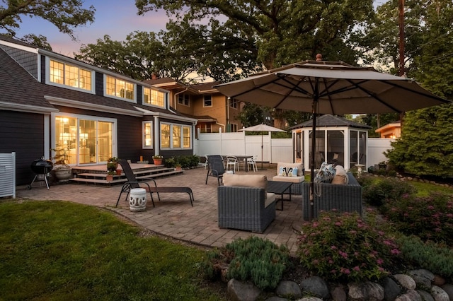 1064 Lombard Ave, Saint Paul, MN 55105 - patio terrace at dusk with a patio area and a fenced backyard