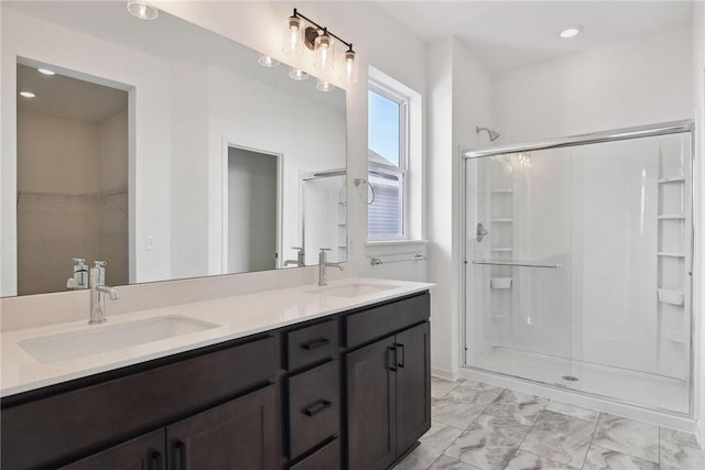 1682 Tyrone Dr, Shakopee, MN 55379 - full bathroom with marble look tile flooring, a stall shower, double vanity, a walk in closet, and recessed lighting
