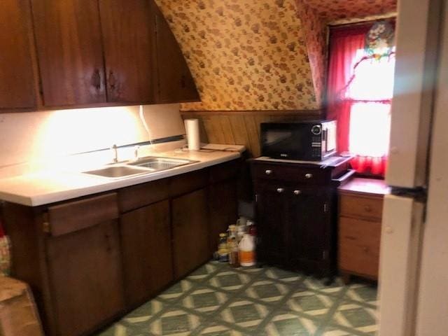 604 Elliott Ave N, Glencoe, MN 55336 - kitchen with black microwave, wallpapered walls, wainscoting, and light countertops