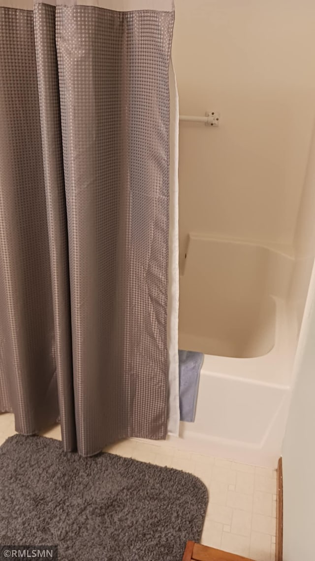 10933 57th St NE, Albertville, MN 55301 - bathroom with tile patterned flooring and shower / bath combo with shower curtain