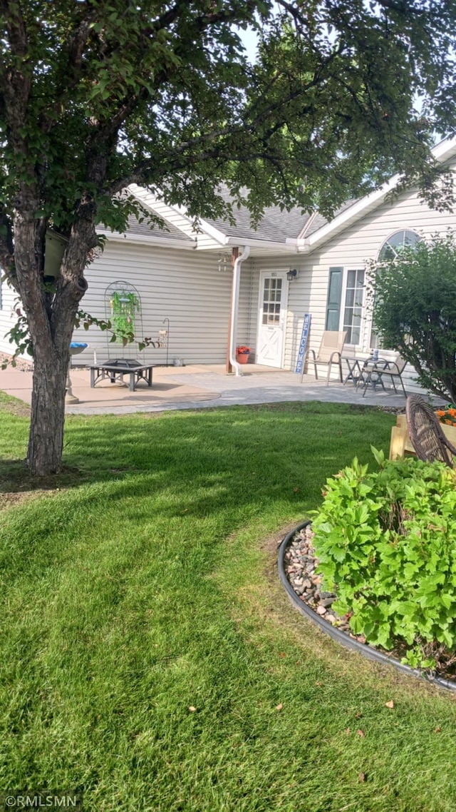10933 57th St NE, Albertville, MN 55301 - back of house featuring a lawn and a patio