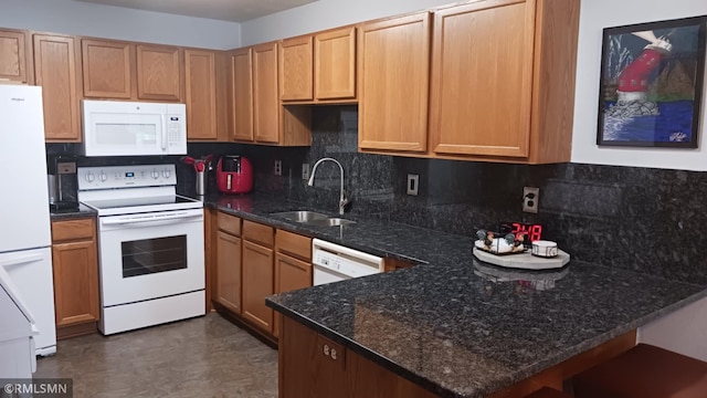 10933 57th St NE, Albertville, MN 55301 - kitchen with white appliances, a peninsula, backsplash, and dark stone countertops